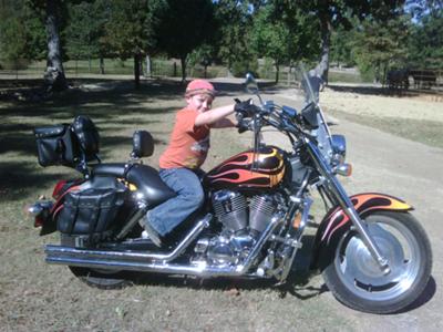  That's our youngest Grandson & Grandchild sitting on my bike.I have added more stuff onto it now. This was taken Summer of 2010.