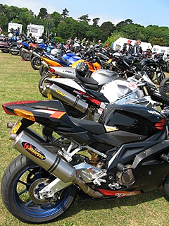 More motorcycles parked in a field.