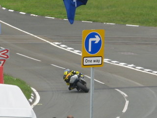 TT racer entering curve on mountain course
