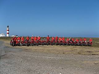 The entire Moto Guzzi group on the Isle of Man, posing with their vintage MG motorcycles.