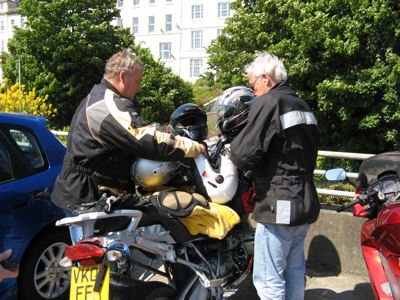 trying to secure way too many helmets with a cable to one motorcycle