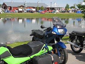 Motorcycles and camping tents at a rally.