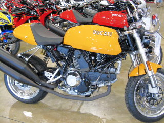 Shiny, bright new yellow Ducati, waiting for a new home.